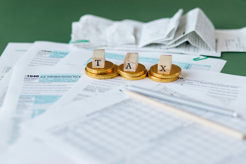 pexels photo 6863183 6863183 1 Close-up of tax forms, receipts, and coins symbolizing financial accounting and taxes.