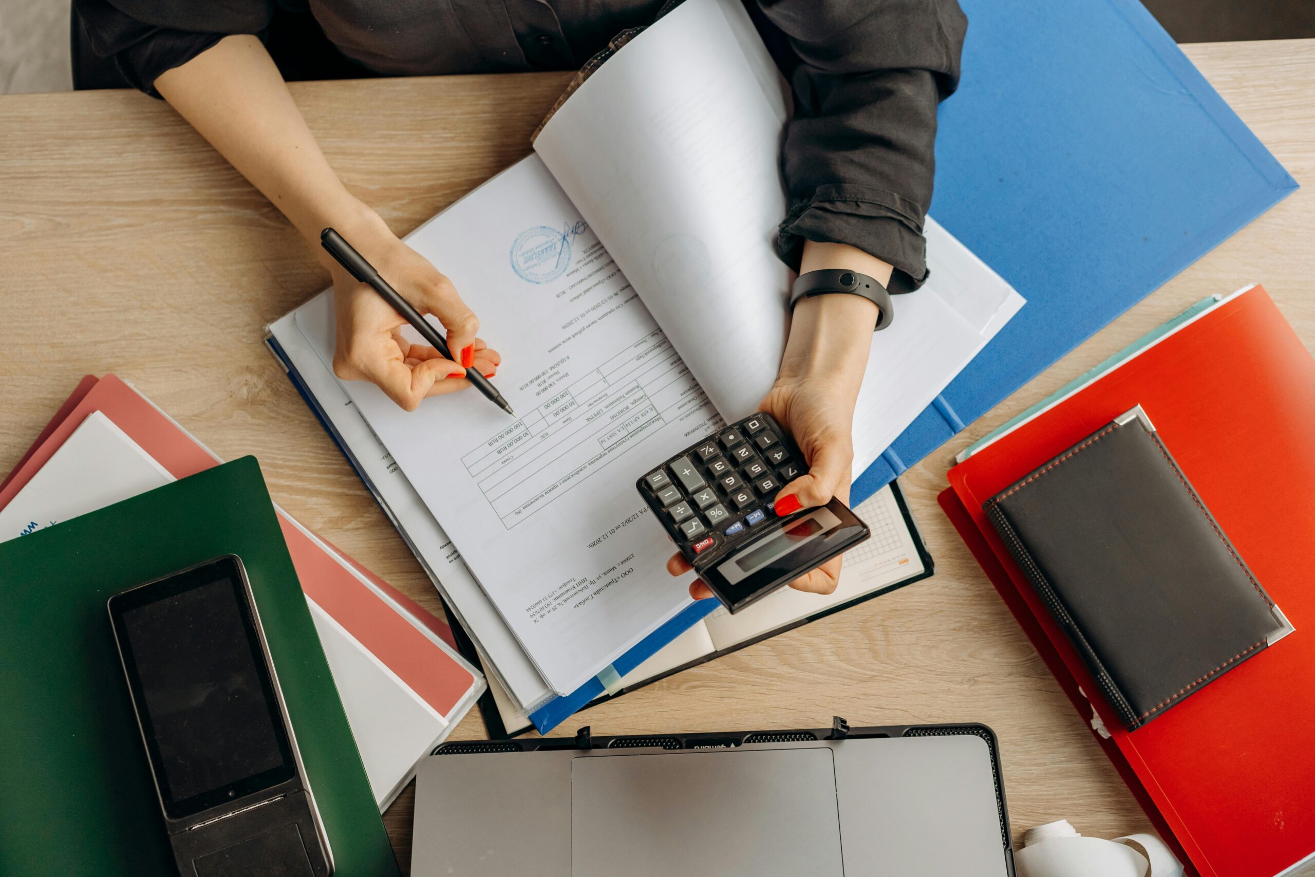 pexels photo 8296970 8296970 Accountant analyzing financial documents with a calculator on a desk, highlighting business tasks.